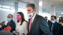 FILE - Sen. Joe Manchin, a Democrat representing West Virginia and a key holdout on President Joe Biden's domestic agenda, is surrounded by reporters at the Capitol in Washington, Nov. 2, 2021.