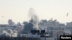 A missile lands as smoke rises during Israeli air strikes in Gaza City, May 5, 2019. 