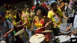 A woman sporting a Chapulin Colorado costume, from the Mexican television series, drums during the "Chroma Aqui na Minha Mao" street party in Rio de Janeiro, Brazil, Feb 8, 2018.