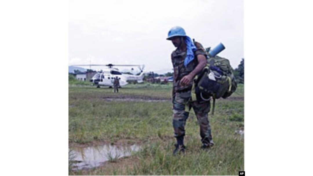 UN troops walk past as they provide security for villagers at the small village of Walikale (File)