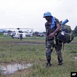 UN troops walk past as they provide security for villagers at the small village of Walikale (File)