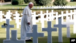Pope Francis walks past marble crosses at the American military cemetery in Nettuno, Italy, Nov. 2, 2017. 