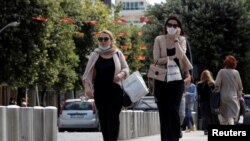 FILE PHOTO: Women wearing masks walk on a street after Prime Minister Dusko Markovic declared the country the coronavirus disease (COVID-19)-free in Podgorica, Montenegro, May 25, 2020. REUTERS/Stevo Vasiljevic/File Photo