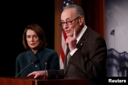 FILE - Senate Minority Leader Chuck Schumer, accompanied by House Minority Leader Nancy Pelosi, speaks at a news conference about the omnibus spending bill moving through Congress on Capitol Hill in Washington, March 22, 2018.