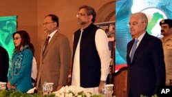 In this photo released by Press Information Department, Former Pakistani Prime Minister Shahid Khaqan Abbasi, center, attends the International Counter Terrorism Forum in Islamabad, Pakistan, April 5, 2018.