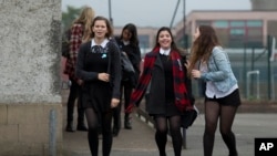 School pupils joke with each other as they leave a polling station, as anyone aged over 16 were allowed to vote in the Scottish independence referendum, in Edinburgh, Scotland, Thursday, Sept. 18, 2014. Some are trying to win 16-year-olds the right to vote in the United States. (AP Photo/Matt Dunham)