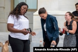 Rep. Cori Bush, D-Mo., and Rep. Alexandria Ocasio-Cortez, D-N.Y., have an impromptu dance party to "Run the World (Girls)" by Beyonce after it was announced that the Biden administration will enact a targeted nationwide eviction moratorium outside of Capitol.