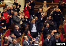 Ukrainian opposition members celebrate during the voting in parliament in Kyiv, Feb. 20, 2014.