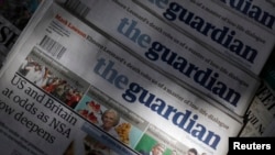Copies of the Guardian newspaper are displayed at a newsstand in London, August 21 2013.