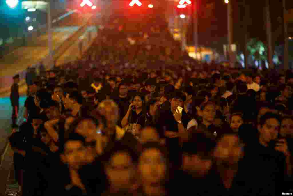 Mourners line up to offer sandalwood flowers at a replica of the Royal Crematorium during the funeral of Thailand's late King Bhumibol Adulyadej in Bangkok,