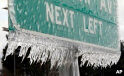 Icicles, formed by freezing rain and stiff winds, hang from a road sign along Interstate 84 in Troutdale, Ore., Jan. 18, 2017.