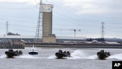 Police and Royal Marines boats perform during a combined Police and Royal Marines security exercise on the River Thames in London in preparation for the 2012 Olympics, January 19, 2012.