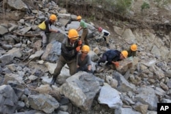 FILE - Workers repair the flood-damaged train track between Sinjon and Kanphyong train stations, North Hamgyong Province, North Korea, Sept. 16, 2016.