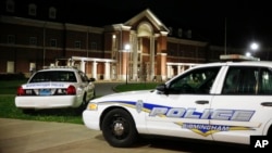 Huffman High School is seen behind Birmingham Police cars after a fatal shooting, March 7, 2018, in Birmingham, Alabama.