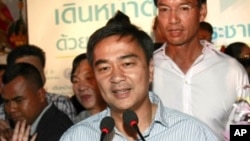 Thai Prime Minister and leader of Democrat Party Abhisit Vejjajiva gestures during a news conference at the party's headquarters Sunday, July 3, 2011 in Bangkok, Thailand