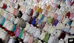 FILE - Muslim women perform an evening prayer in Jakarta, Indonesia, June 5, 2016. Only 29 percent of young people in a recent U.S. survey were able to pinpoint Indonesia as being a Muslim-majority country.