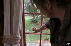 Livestock breeder Maria Dodds shows a bullet hole in a window after her home was attacked by armed herders in Laikipia, Kenya, July 26, 2017.