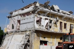 FILE - The badly damaged building of Nasa-Hablod hotel stands in Mogadishu, Somalia, Sunday, June 26, 2016.