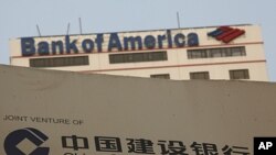 A construction site of the Hong Kong headquarters of China Construction Bank (Asia) is seen in front of Bank of America Tower at Hong Kong's financial Central district, August 25, 2011