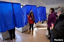 FILE - A voter leaves the polling booth during the U.S. presidential election in Philadelphia, Nov. 8, 2016.