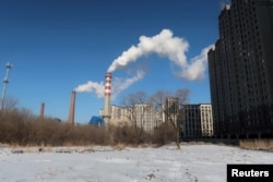 A coal-fired power plant complex is seen behind snow-covered ground in Harbin, Heilongjiang Province, China, November 15, 2019. (REUTERS/Muyu Xu)