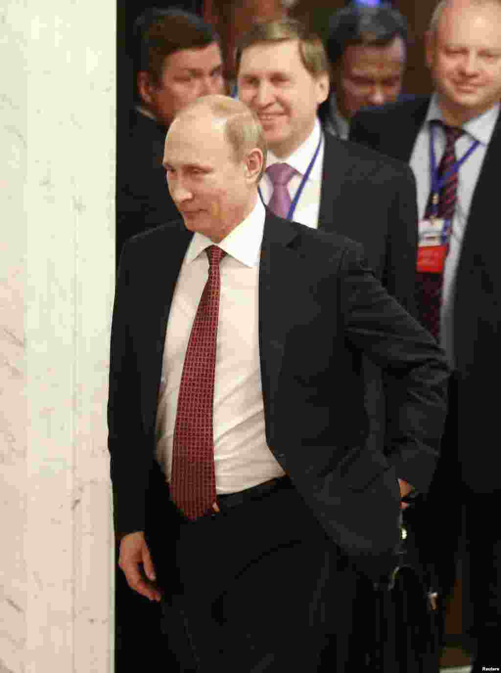 Russia's President Vladimir Putin (front) walks as he attends a peace summit to resolve the Ukrainian crisis in Minsk, February 12, 2015.