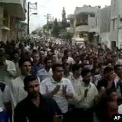 An image from footage uploaded on YouTube shows Syrian anti-government protesters flooding the streets of the central city of Hama, July 8, 2011, to demand the fall of the regime President Bashar al-Assad
