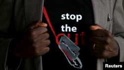 FILE - A man’s T-shirt reads “Stop the Cut,” a reference to female genital mutilation, during a social event advocating against such harmful practices at the Imbirikani Girls High School in Imbirikani, Kenya, April 21, 2016.
