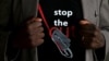 FILE - A man's T-shirt reads "Stop the Cut" referring to Female Genital Mutilation during a social event advocating against such harmful practices at the Imbirikani Girls High School in Imbirikani, Kenya, April 21, 2016.