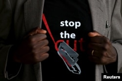 FILE - A man's T-shirt reads "Stop the Cut" referring to Female Genital Mutilation during a social event advocating against such harmful practices at the Imbirikani Girls High School in Imbirikani, Kenya, April 21, 2016.