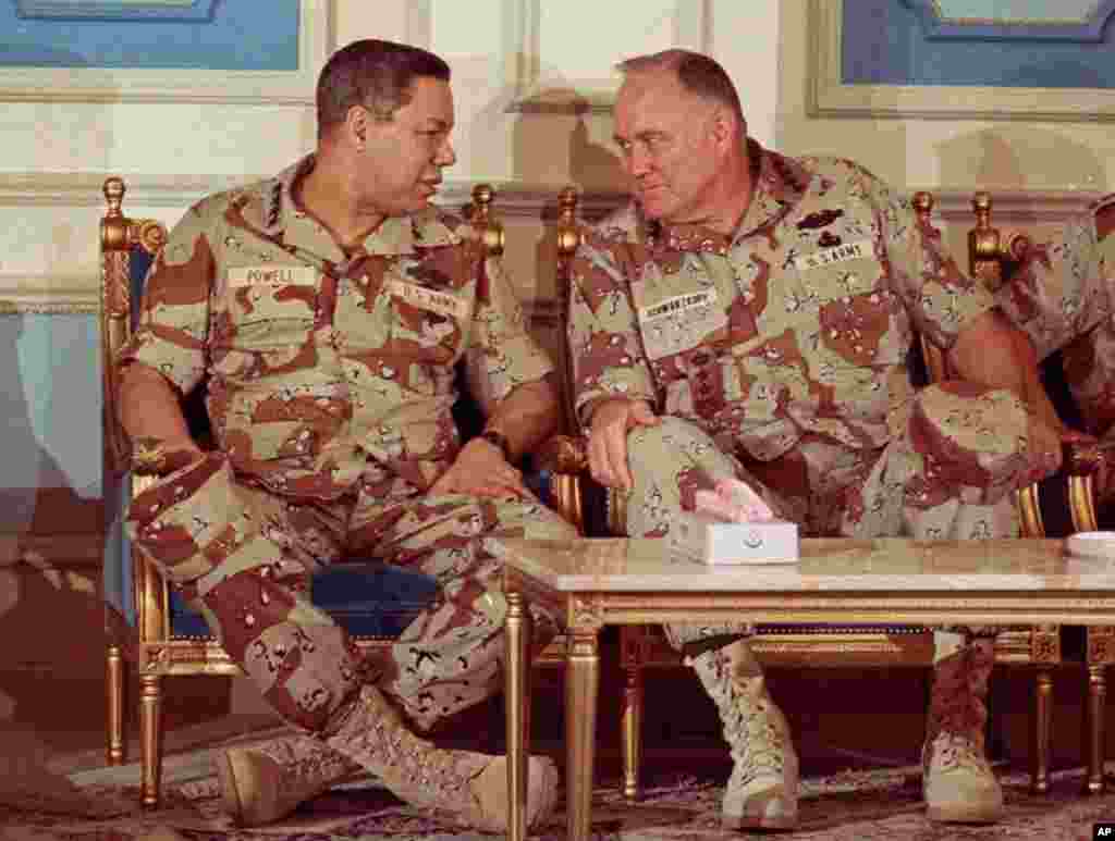 Then Chairman of the Joint Chiefs of Staff Geneneral Colin Powell, left, confers with General Norman Schwarzkopf at an airbase in central Saudi Arabia on February 8, 1991.