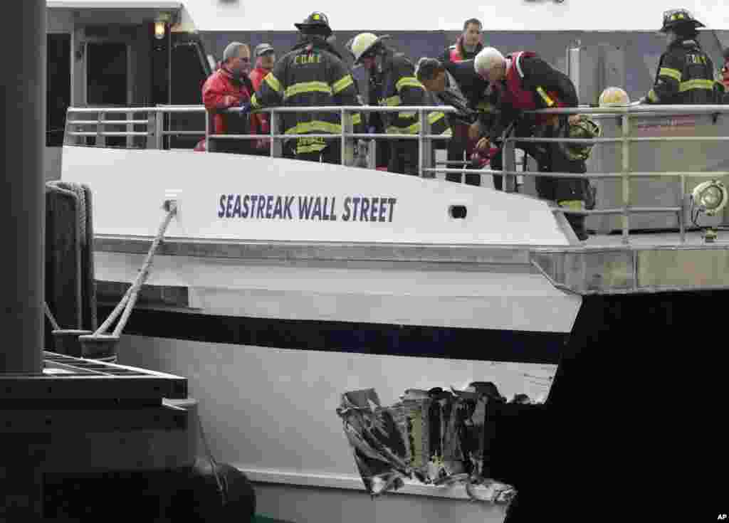 New York City firefighters walk the deck of the Seastreak Wall Street ferry in New York, January 9, 2013.