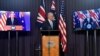 Australia's Prime Minister Scott Morrison, center, appears on stage with video links to Britain's Prime Minister Boris Johnson, left, and U.S. President Joe Biden at a joint press conference at Parliament House in Canberra, Thursday, Sept. 16, 2021. 