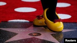 The character of Minnie Mouse poses on her star after it was unveiled on the Hollywood Walk of Fame in Los Angeles, California, Jan. 22, 2018.