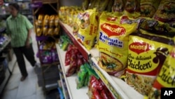 FILE - Packaged food with "Maggi" sign on it are displayed at a grocery store in Bangalore, India, June 5, 2015. 