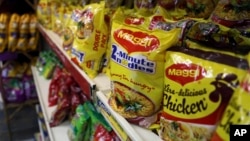 FILE - Packaged food with "Maggi" sign on it are displayed at a grocery store in Bangalore, India, June 5, 2015. 