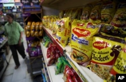 Packaged food with "Maggi" sign on it are displayed at a grocery store in Bangalore, India.