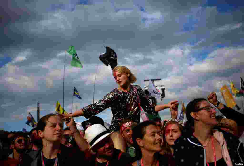 Revelers cheer as ZZ Top perform on The Pyramid stage at Worthy Farm in Somerset during the Glastonbury Festival, Britain.