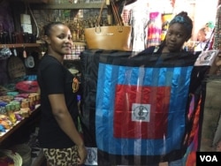 Chadema supporters show their party flag in a curio shop in Dar es Salaam, Oct. 24, 2015. (Jill Craig/VOA)