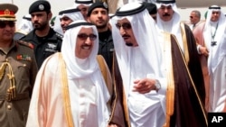 FILE - King Salman of Saudi Arabia (R) welcomes Kuwaiti Emir Sabah Al Ahmed Al Sabah upon his arrival to Riyadh Airbase before the opening of Gulf Cooperation Council summit in Riyadh, Saudi Arabia, May 2015.
