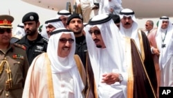 File - King Salman of Saudi Arabia (R) welcomes Kuwaiti Emir Sabah Al Ahmed Al Sabah upon his arrival to Riyadh Airbase before the opening of Gulf Cooperation Council summit in Riyadh, Saudi Arabia, May 2015.