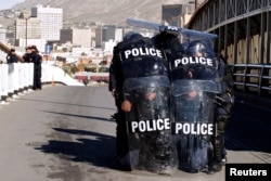 U.S. Custom and Border Protection agents with full riot gear take part in a drill to protect the crossing gates against people who want to cross the border illegally on the international bridge between Mexico and the U.S., in Ciudad Juarez, Mexico,