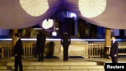 Japan's Finance Minister Taro Aso (2nd R) bows as he visits the Yasukuni Shrine in Tokyo, in this photo provided by Kyodo, April 21, 2013.