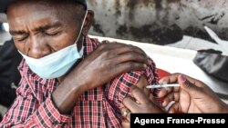 FILE - A man gets a COVID-19 vaccine in Nairobi, Kenya, on Sept. 17, 2021. 