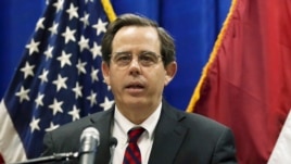 In this Oct. 1, 2015, photo, Stuart Jones speaks at a news conference at the U.S. Embassy in Baghdad, Iraq. The Trump administration is accusing the Syrian government of carrying out mass killings of thousands of prisoners and burning the dead bodi
