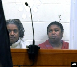 FILE - In this Feb. 1, 2018 file photo, sisters Rachel Hilaire and Peggy LaBossiere sit in Brockton District Court in Bridgewater, Mass.