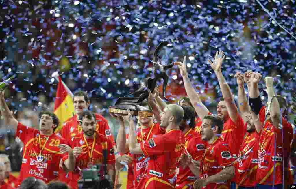 Spanish players raise the trophy after winning the final match of the Handball World Championships between Spain and Denmark at Palau Sant Jordi in Barcelona, Spain.