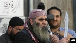 A Salafi protester holds a sword during a demonstration for extremist Salafi Muslims in the town of Zarqa, east of Amman, Jordan, April 15, 2011