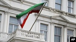 British police stand guard outside the Iranian Embassy in London. Britain's foreign secretary on Wednesday ordered all Iranian diplomats out of the U.K within 48 hours following attacks on the British embassy and a residential compound in Tehran, November