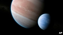 This illustration provided by Dan Durda shows the exoplanet Kepler-1625b with a hypothesized moon. On Thursday, Oct. 4, 2018, two Columbia University researchers reported their results that the potential exomoon would be the size of Neptune or Uranus. The exoplanet, about 8,000 light-years away, is as big as Jupiter. (Dan Durda via AP)